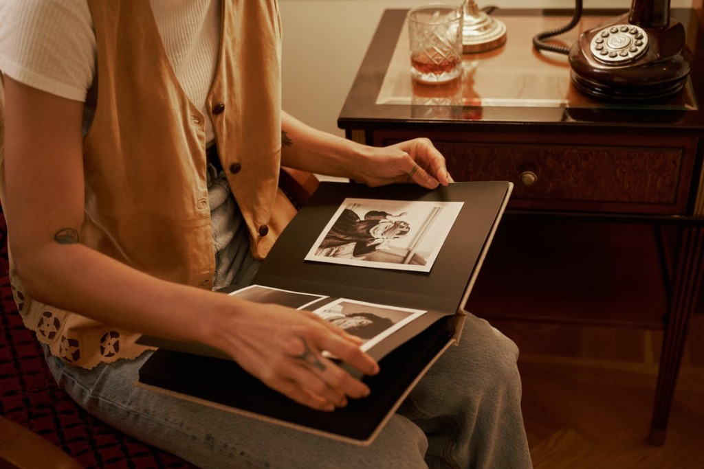 A person looking at a photo album with black and white photographs