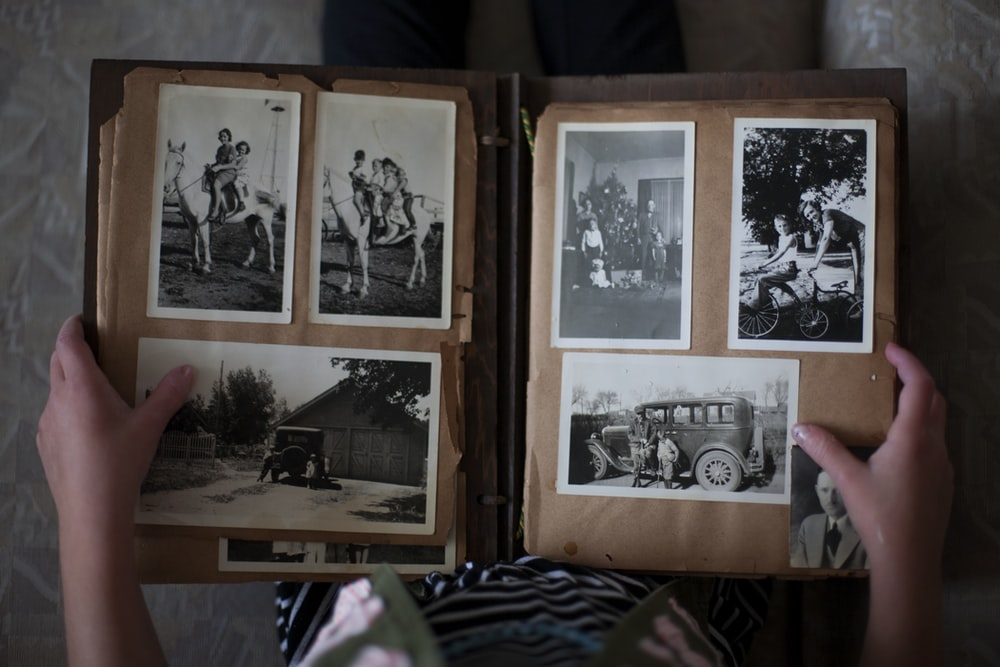An old photo album with greyscale photographs