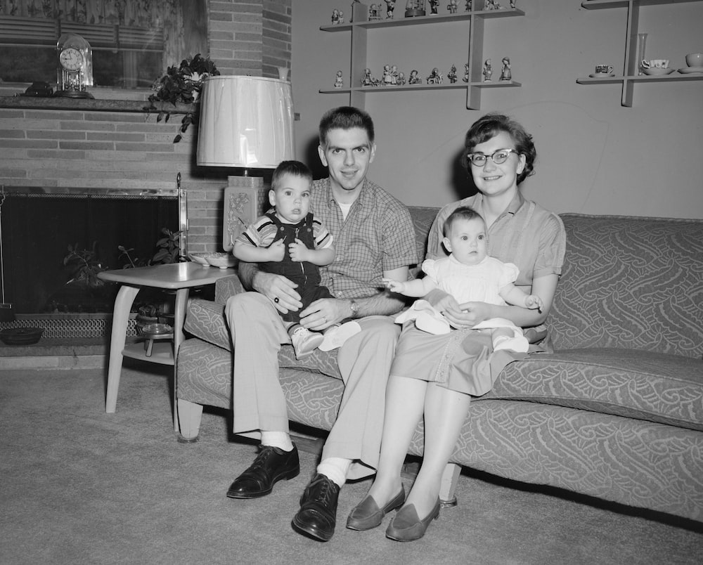 An old grey-scale photograph of a couple with two small children