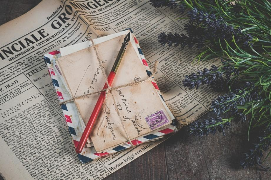 A bundle of letters on a newspaper 