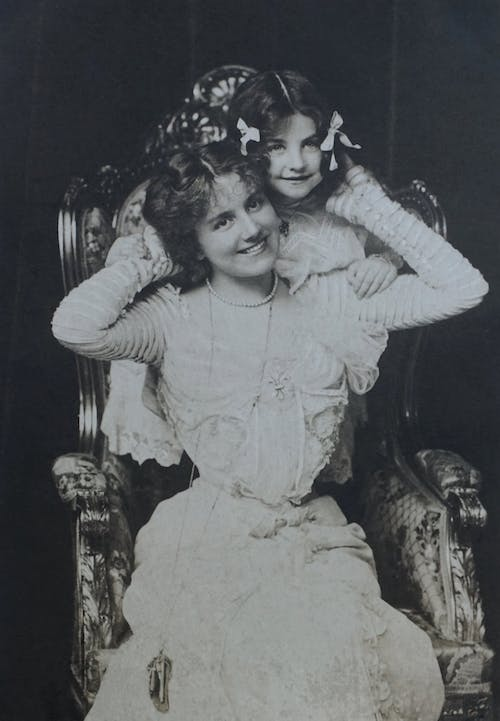 An old photo of a mother posing with her daughter