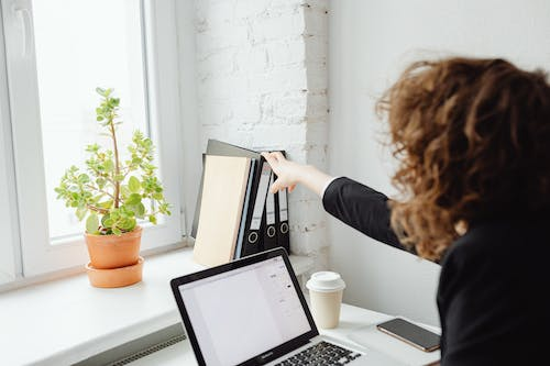 A person reaching out for a folder