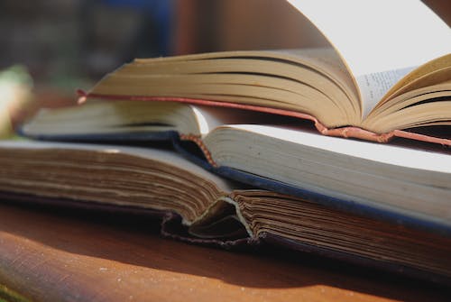 Three books open on top of each other