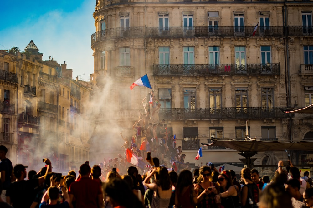 People with French flags on a street 