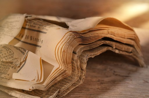 A very old, partially torn newspaper