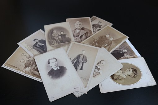 Black and white photos scattered on a surface