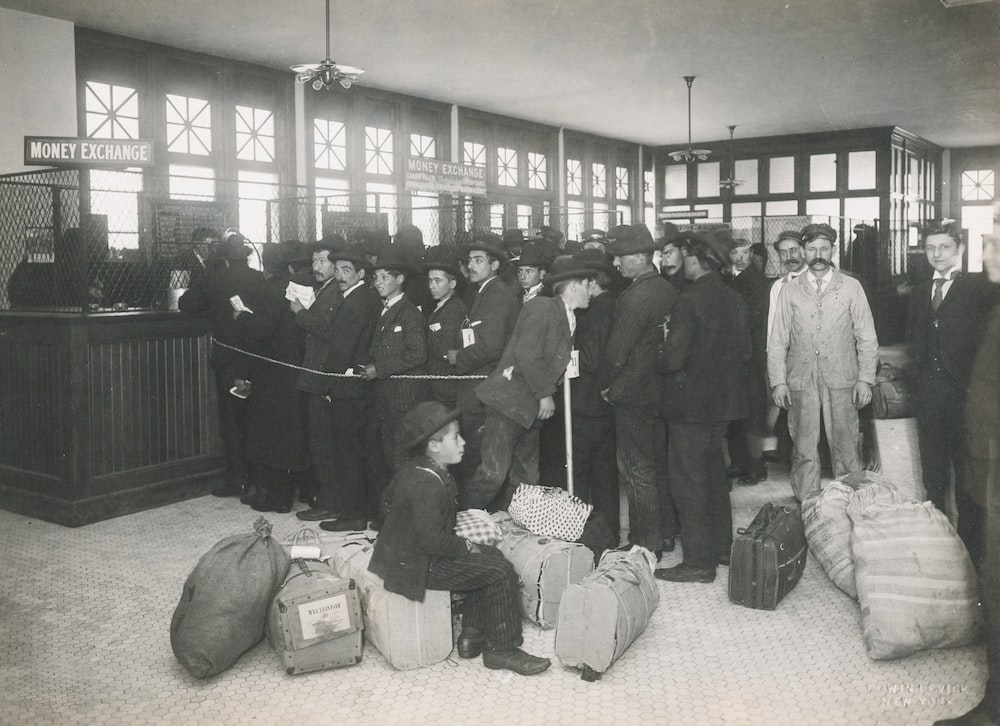 A grey-scale photo of immigrants at Ellis Island