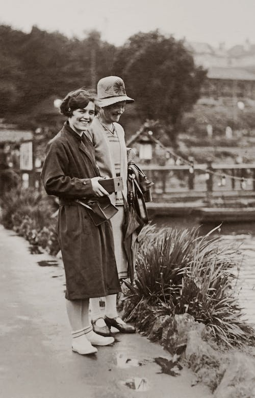 A couple by the lake in a greyscale photograph