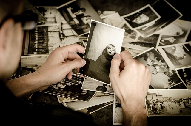 A person holding a black and white photograph