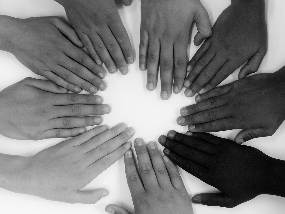 Hands belonging to people from different races and ethnicities  