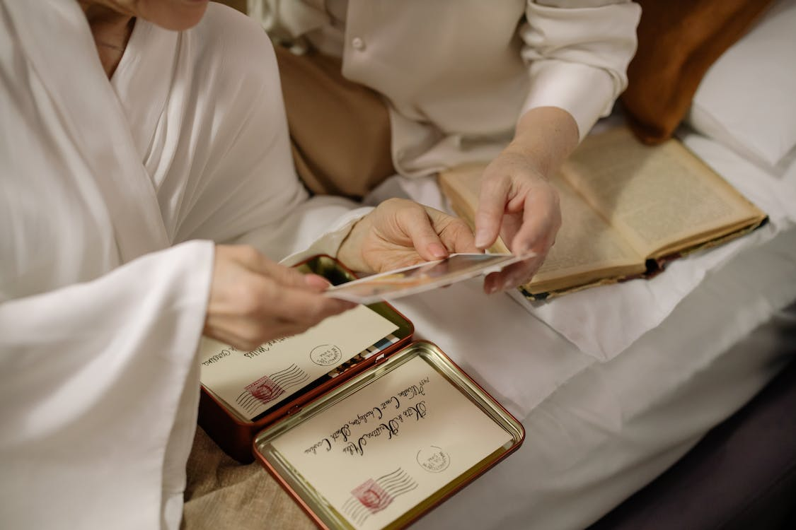 two people looking at old photos and letters