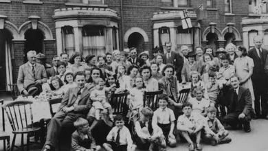 A black and white photograph showing a large family with multiple generations