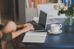 A person typing on a laptop 