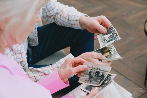 Two people looking at old photos 