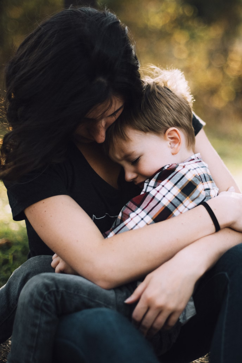 a woman hugging her child.
