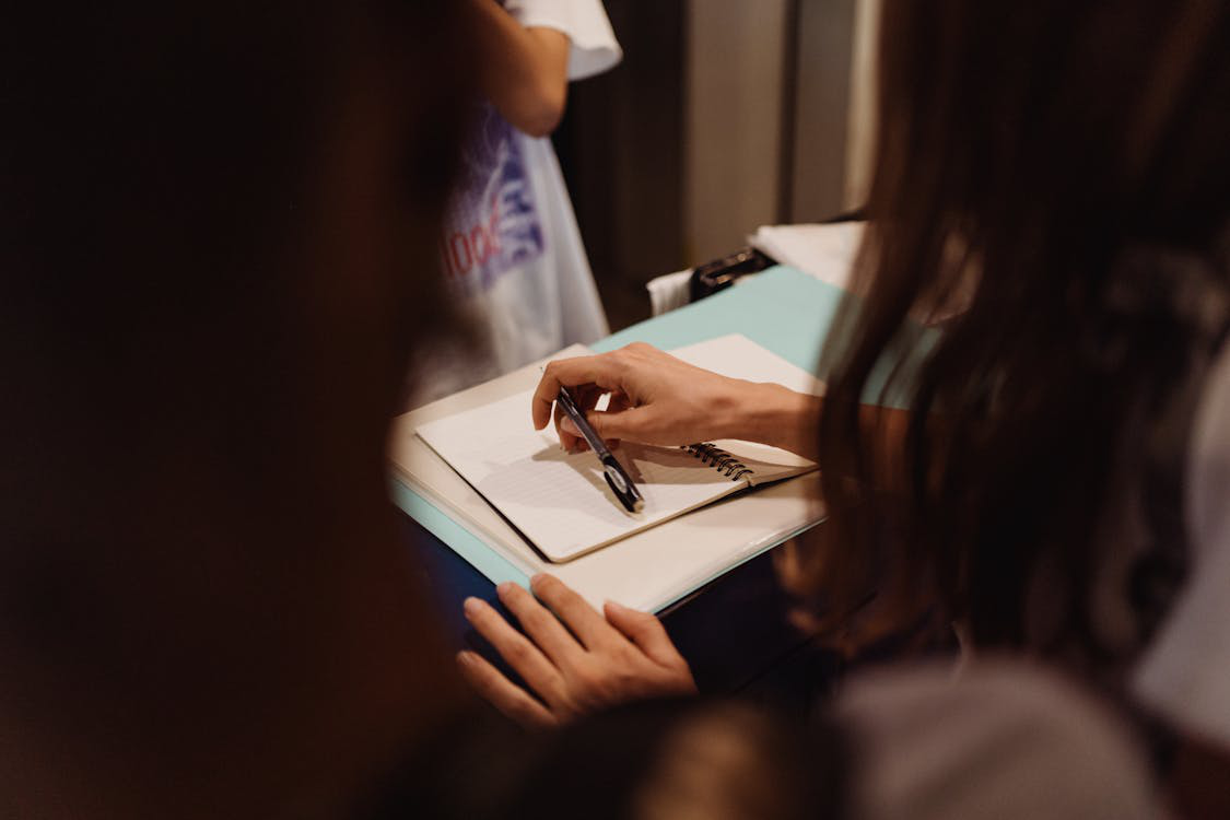 a woman holding a pen.