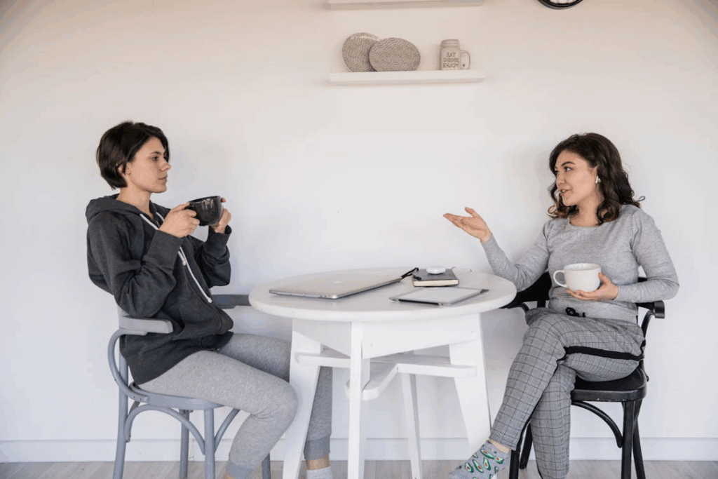 two women sitting and having coffee.