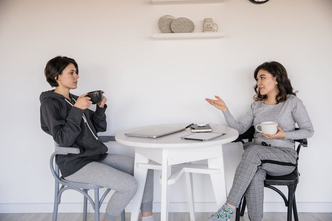 two women sitting and having coffee.