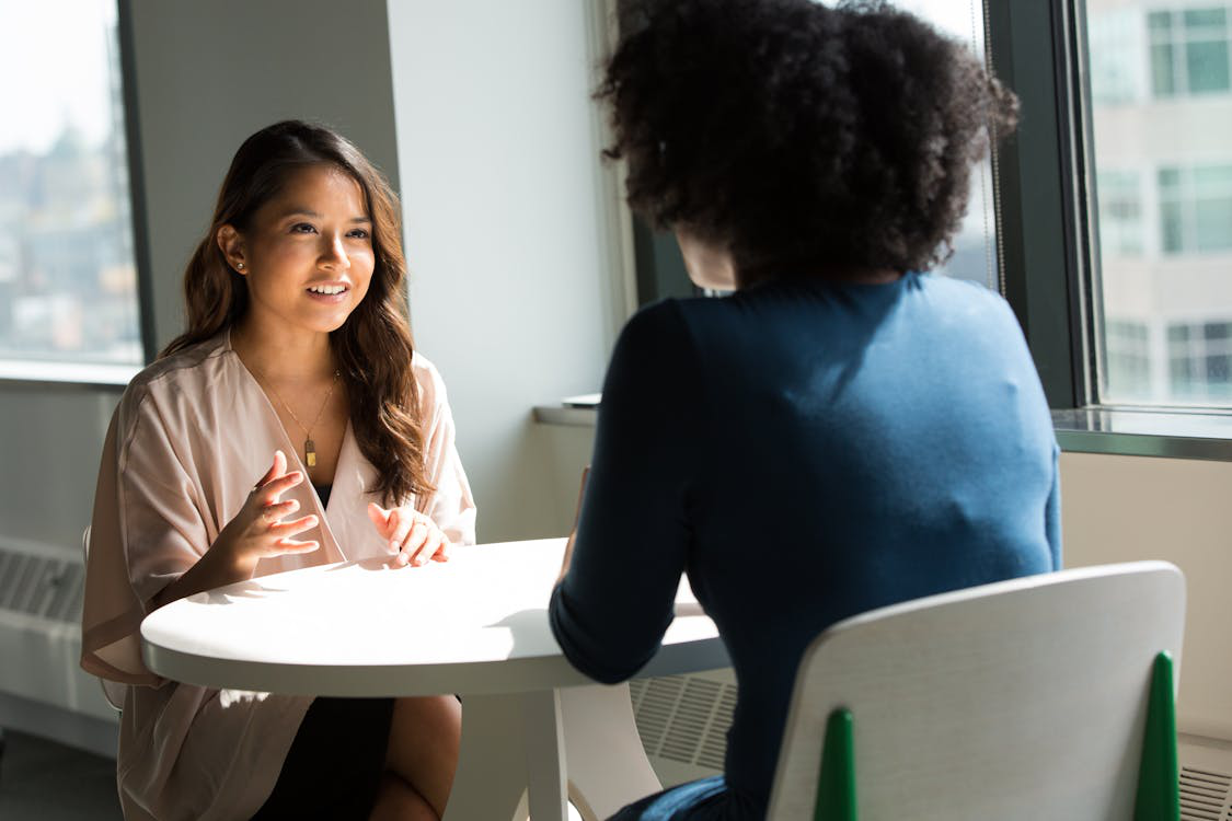 women sitting and having a conversation.