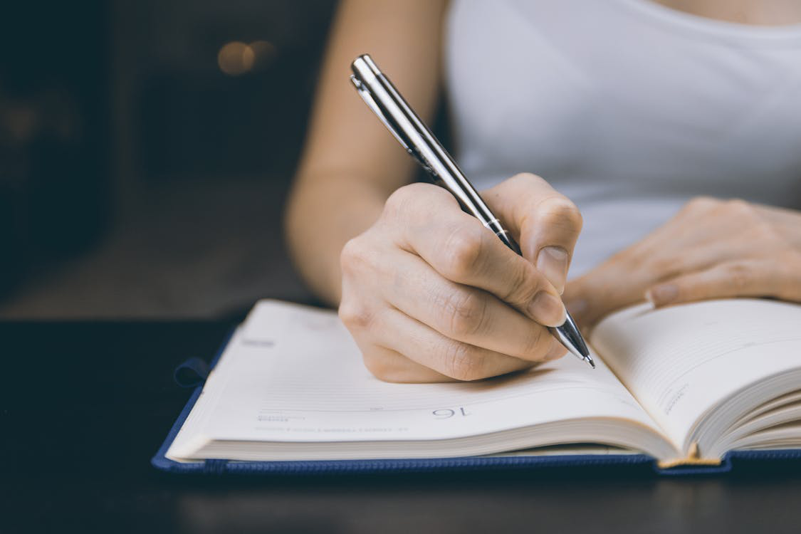 a person writing in their notebook.