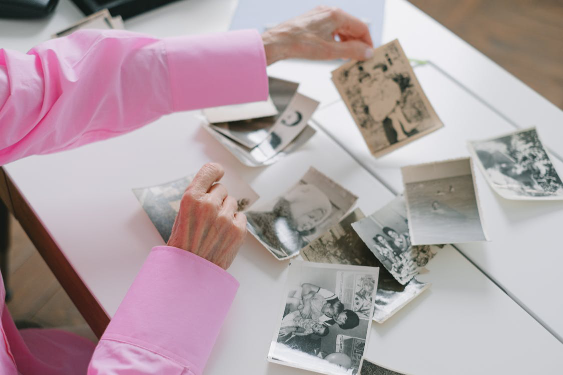  a person looking at old photographs.