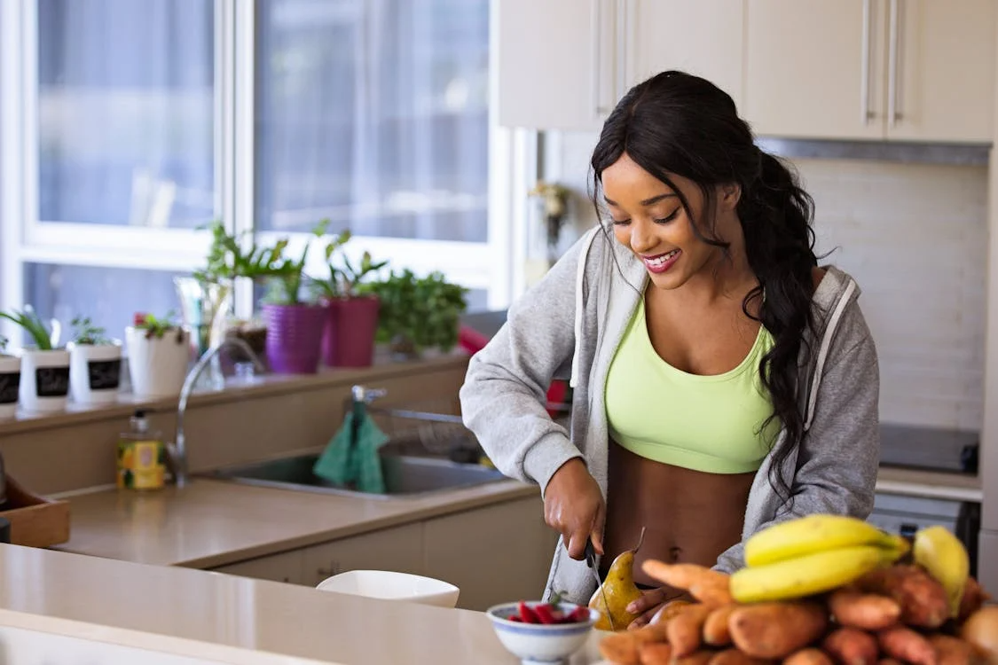 a woman cutting up fruits.