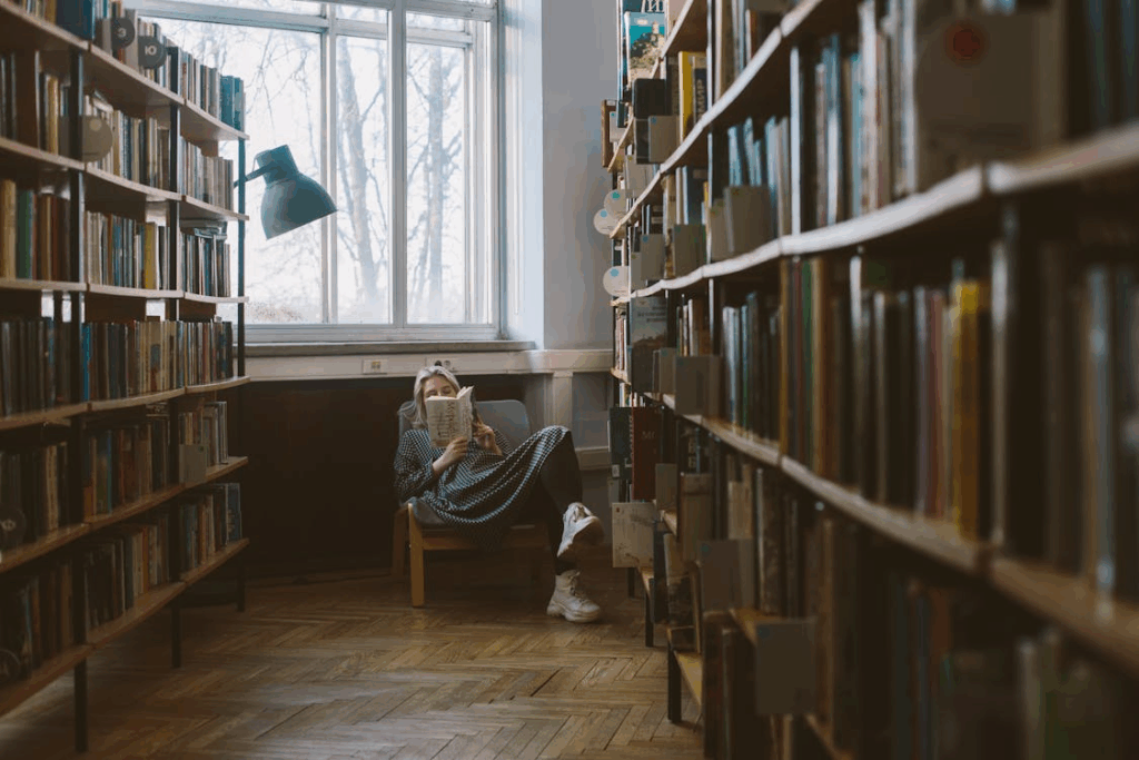 a woman reading at the library.