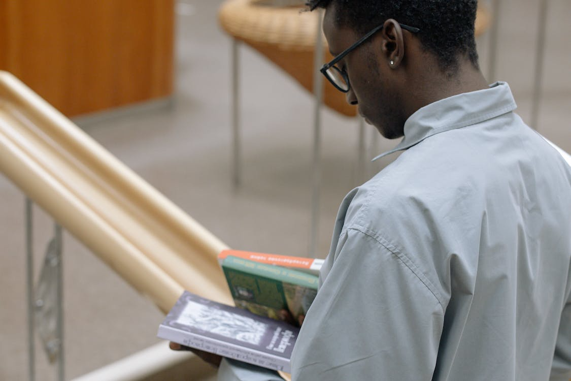 a man holding books.