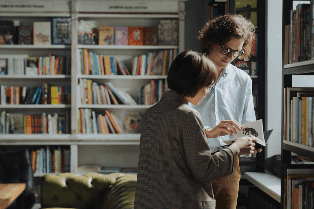 a man and a woman going through a book.