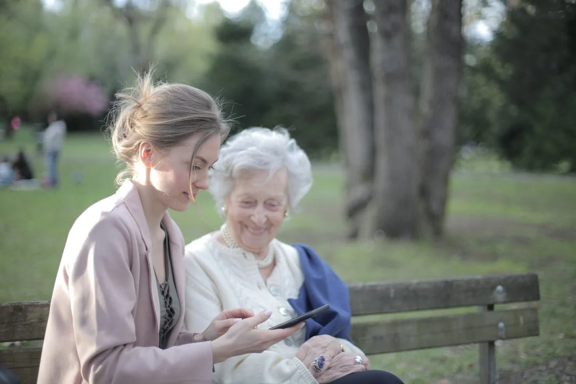 women sitting outdoors.