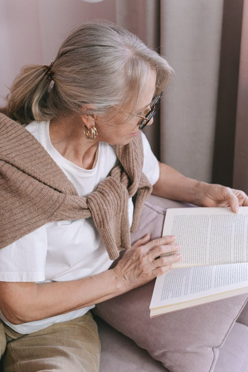 a woman sitting and reading a book.