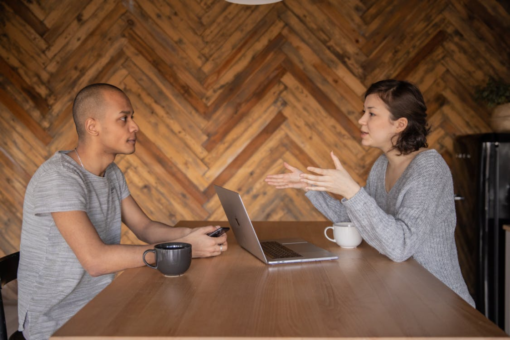 two people sitting and having a conversation.