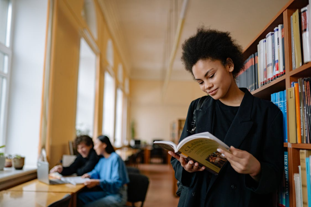 a woman standing in a library.