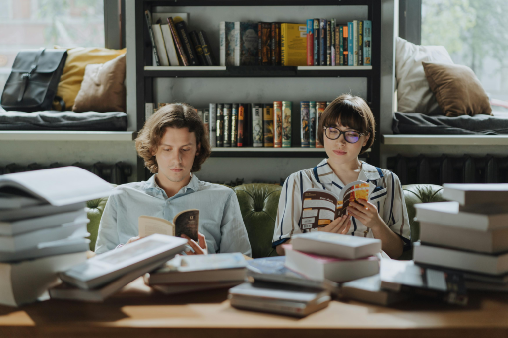 a man and a woman sitting on a green couch.