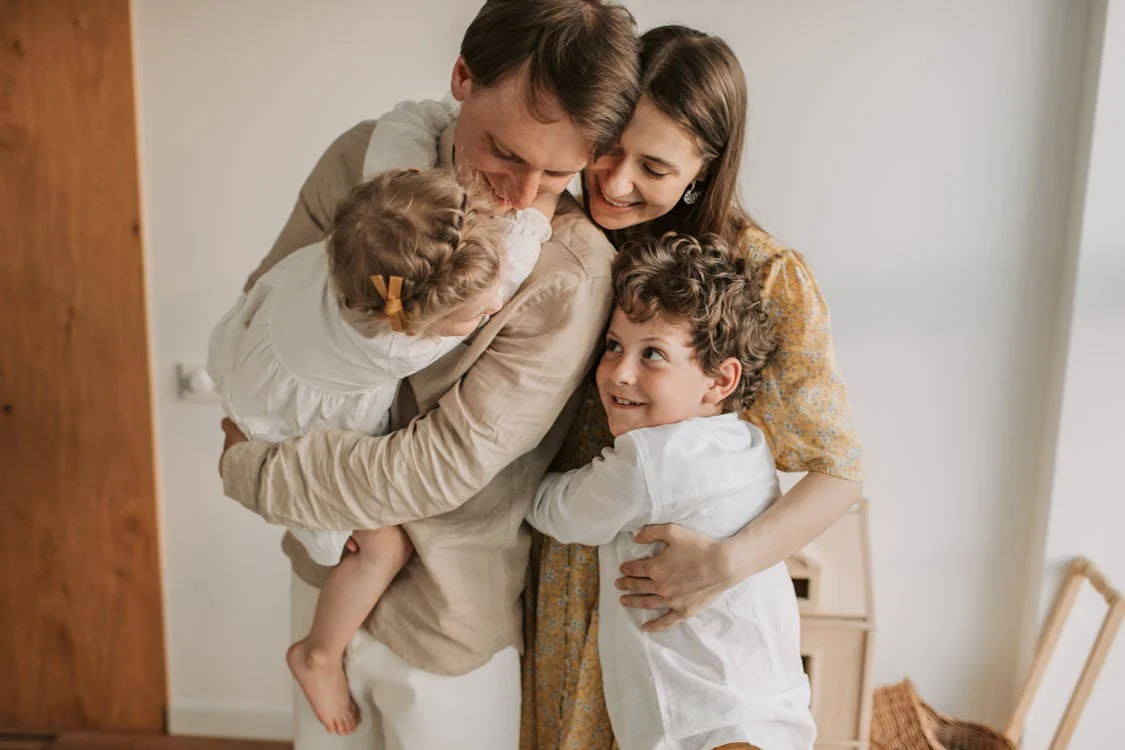 a family hugging each other.