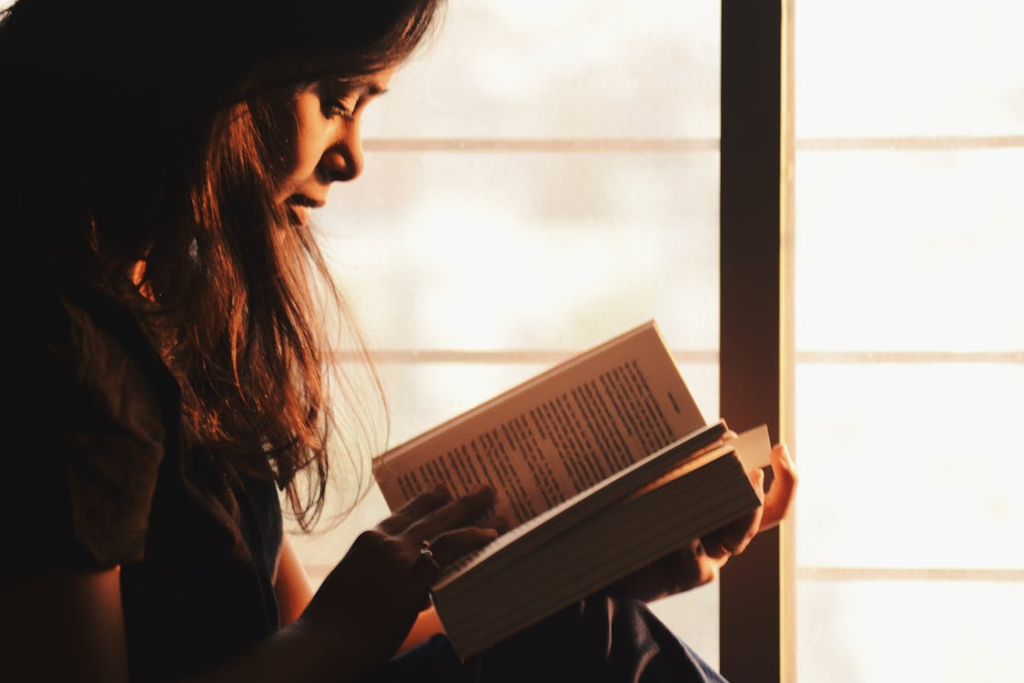a woman reading by the window.