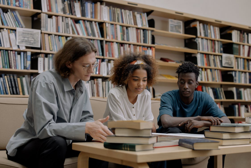 three people sitting and doing research.