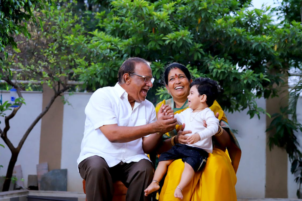 grandparents playing with their grandchild.