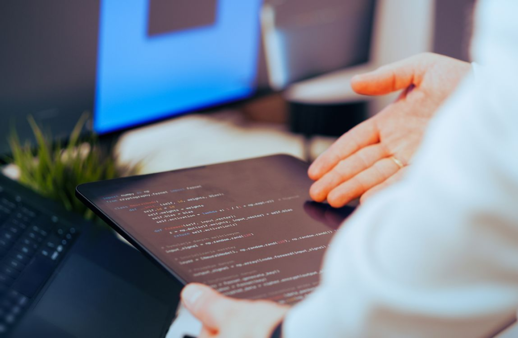 a person holding a tablet and organizing family history data.
