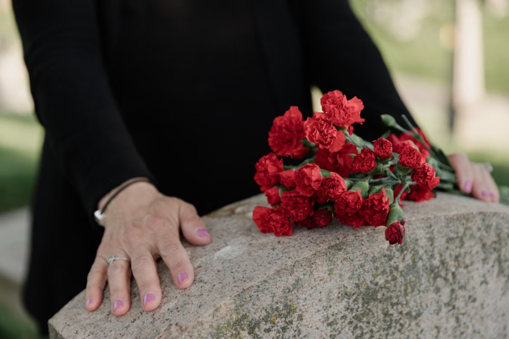 a man standing in front of a gravestone