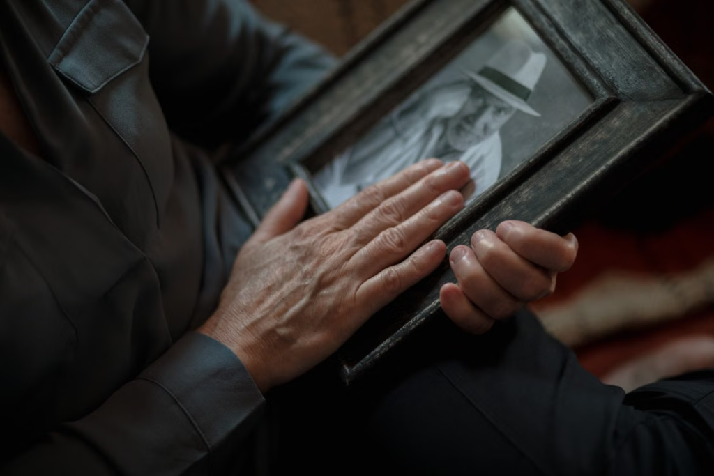 a man looking at an old photograph.