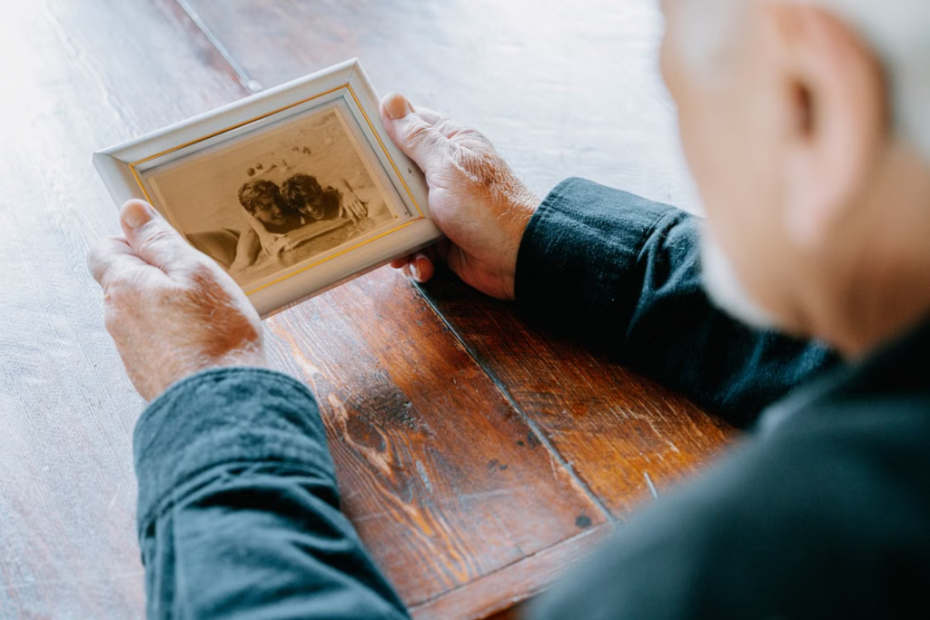 a man holding a framed photograph.